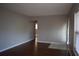 A brightly lit living room showcasing hardwood floors, light walls, and a door with large window to the right at 2484 Roberta St, Largo, FL 33771
