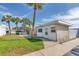 Exterior view of the single-story building with palm trees and well-maintained landscaping at 250 Rosery Nw Rd # 288, Largo, FL 33770