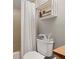 This bathroom has a toilet with a decorative shelf, and a shower with a shower curtain at 2632 Enterprise E Rd # A23, Clearwater, FL 33759