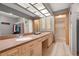 This bathroom features a double vanity with a light countertop and two separate doors to shower and closet at 2632 Enterprise E Rd # A23, Clearwater, FL 33759
