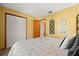 This bedroom features yellow walls, a closet, and light-colored wood-look flooring at 2632 Enterprise E Rd # A23, Clearwater, FL 33759