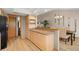 Open kitchen and dining area with wood cabinets, laminate countertops, and stainless steel refrigerator at 2632 Enterprise E Rd # A23, Clearwater, FL 33759
