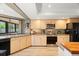 Bright kitchen with stainless steel appliances, wood cabinets, and a view to the outside at 2632 Enterprise E Rd # A23, Clearwater, FL 33759
