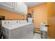 This laundry room features a washing machine, dryer, and a utility sink at 2632 Enterprise E Rd # A23, Clearwater, FL 33759