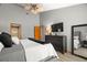 This primary bedroom features gray walls, a ceiling fan, and a dresser with a TV at 2632 Enterprise E Rd # A23, Clearwater, FL 33759