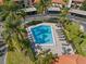 Aerial view of a community pool surrounded by well-maintained landscaping and lounge chairs at 2632 Enterprise E Rd # A23, Clearwater, FL 33759