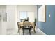 Inviting dining area with a modern table set, natural light, and stylish decor, creating a warm ambiance at 32027 Spiceberry St, San Antonio, FL 33576