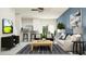 Bright living room featuring modern furnishings, a breakfast bar, and an open floor plan at 32027 Spiceberry St, San Antonio, FL 33576