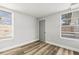 Light-filled bedroom with two windows and modern flooring at 3333 Chauncy Rd, Holiday, FL 34691