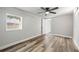 Bright bedroom featuring a ceiling fan and large window at 3333 Chauncy Rd, Holiday, FL 34691