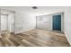 Inviting living room featuring modern flooring, a blue front door, and lots of natural light at 3333 Chauncy Rd, Holiday, FL 34691