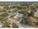 An aerial view shows the property nestled in a neighborhood with mature trees and a well-maintained yard at 3405 Phillips St, Tampa, FL 33619