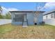 A home showcasing a backyard with a fenced in yard and covered porch at 3405 Phillips St, Tampa, FL 33619