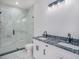 Modern bathroom featuring a double sink vanity with granite countertop and frameless glass shower at 3405 Phillips St, Tampa, FL 33619