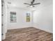 Bright bedroom with hardwood floors, a ceiling fan, and two windows offering natural light at 3405 Phillips St, Tampa, FL 33619