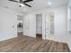 Bedroom with hardwood floors, walk-in closet and open access to kitchen and bathroom at 3405 Phillips St, Tampa, FL 33619