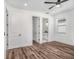 Bedroom with hardwood floors, walk-in closet and open access to a bathroom with granite countertop at 3405 Phillips St, Tampa, FL 33619
