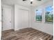 Bedroom featuring hardwood floors, a ceiling fan, two windows and a closet for storage at 3405 Phillips St, Tampa, FL 33619