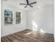 Bright bedroom with hardwood floors, a ceiling fan, and two windows offering natural light at 3405 Phillips St, Tampa, FL 33619