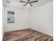 Bedroom with hardwood floors, a ceiling fan, and one window offering natural light at 3405 Phillips St, Tampa, FL 33619