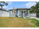 Exterior shot of single-story home boasting a covered front porch and landscaped front yard at 3405 Phillips St, Tampa, FL 33619