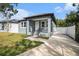 Inviting home featuring a front porch, walkway, and manicured lawn at 3405 Phillips St, Tampa, FL 33619