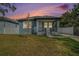 Charming home featuring a cozy front porch and well-maintained lawn at 3405 Phillips St, Tampa, FL 33619
