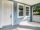 Close up of the covered front porch showing the address and newly painted entry door at 3405 Phillips St, Tampa, FL 33619
