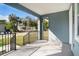 A spacious and airy covered front porch overlooking a green yard at 3405 Phillips St, Tampa, FL 33619