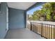 Covered patio with black metal railing and exterior access at 3405 Phillips St, Tampa, FL 33619