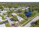Scenic aerial view of a home with mature trees and a tranquil pond in a desirable community at 3462 Sutton Pl, Palm Harbor, FL 34684