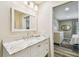 The bathroom is updated with white marble and overlooks the main bedroom at 3462 Sutton Pl, Palm Harbor, FL 34684