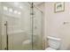 Elegant bathroom featuring a glass-enclosed shower, sleek vanity, and modern fixtures at 3462 Sutton Pl, Palm Harbor, FL 34684