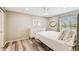 Stylish bedroom featuring a queen-sized bed, dresser, and modern ceiling fan at 3462 Sutton Pl, Palm Harbor, FL 34684