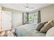 Comfortable bedroom with modern ceiling fan, and a scenic window, offering a relaxing retreat at 3462 Sutton Pl, Palm Harbor, FL 34684