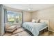 Bright bedroom featuring a ceiling fan, a comfortable chair and large window at 3462 Sutton Pl, Palm Harbor, FL 34684