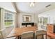 Cozy dining room featuring a wooden table with a large mirror and convenient access to the kitchen at 3462 Sutton Pl, Palm Harbor, FL 34684