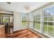 Bright dining room with lots of windows and wood floors at 3462 Sutton Pl, Palm Harbor, FL 34684
