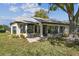 The backyard features a patio and mature trees with a view of the water at 3462 Sutton Pl, Palm Harbor, FL 34684