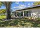 The backyard patio is surrounded by mature landscaping at 3462 Sutton Pl, Palm Harbor, FL 34684