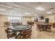 Spacious game room with comfortable seating and game tables, perfect for entertaining and socializing at 3462 Sutton Pl, Palm Harbor, FL 34684