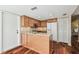 Kitchen featuring a wooden island, stainless steel appliances, and wood cabinets at 3462 Sutton Pl, Palm Harbor, FL 34684