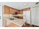 Kitchen features granite counters, stainless steel appliances, and wood cabinets at 3462 Sutton Pl, Palm Harbor, FL 34684