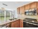 Kitchen with stainless steel appliances and granite countertops at 3462 Sutton Pl, Palm Harbor, FL 34684