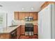 Kitchen with wood cabinets, stainless steel appliances, and granite countertops at 3462 Sutton Pl, Palm Harbor, FL 34684