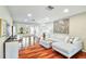 Bright and airy living room featuring hardwood floors, recessed lighting, and a plush white sectional at 3462 Sutton Pl, Palm Harbor, FL 34684