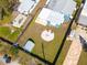 An aerial view showcases the spacious, fenced backyard featuring a firepit, shed, and covered patio at 358 51St N Ave, St Petersburg, FL 33703
