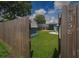 A gated view into the property's backyard showcasing the shed, patio, and firepit, creating an inviting outdoor space at 358 51St N Ave, St Petersburg, FL 33703