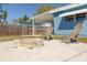 Inviting backyard with a charming fire pit and comfortable Adirondack chairs for outdoor relaxation and entertaining at 358 51St N Ave, St Petersburg, FL 33703