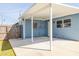 A concrete back patio and blue home exterior featuring large windows at 358 51St N Ave, St Petersburg, FL 33703